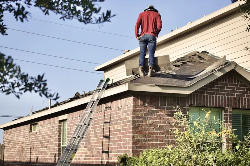Professional roofer working on a residential roof in Fort Bliss